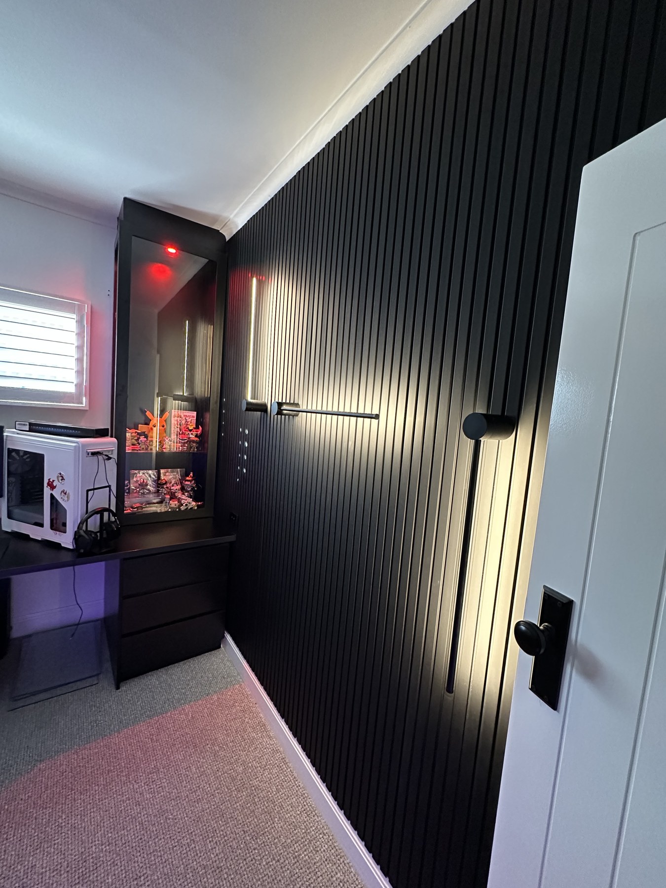 Feature lighting on a dark panelled wall
