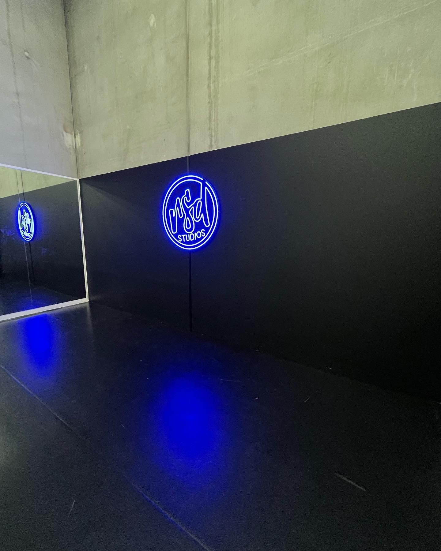 Blue studio sign reflected in the adjacent mirror